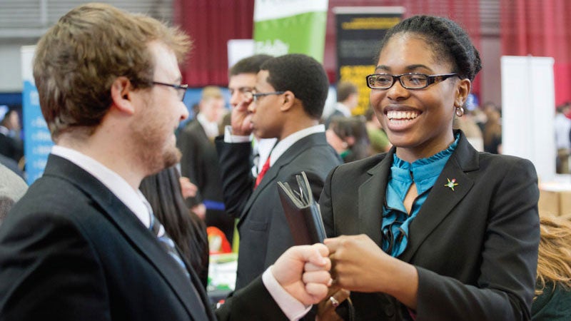 Two students fist pump at the Spring Career Fair