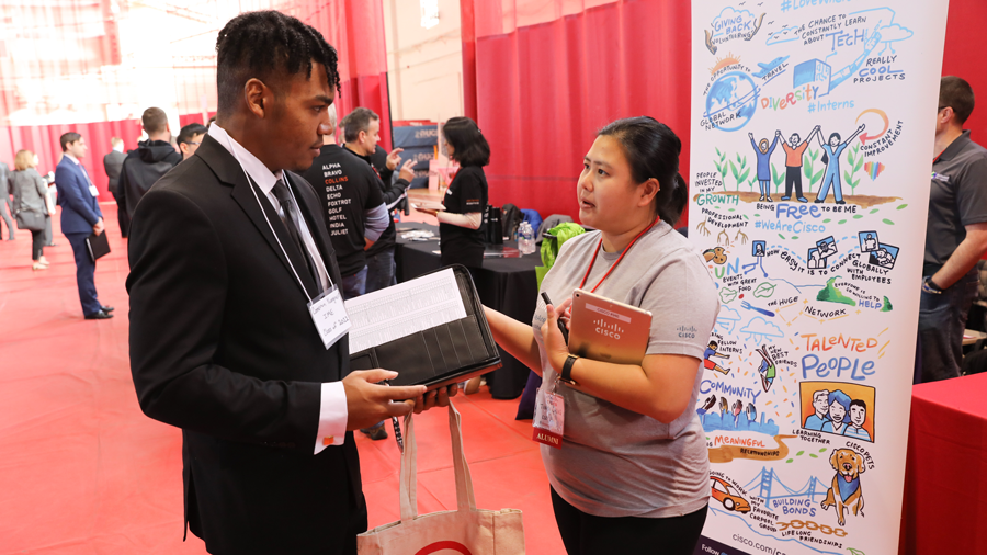 Representative from Cisco systems speaks with RPI student at the Career Fair