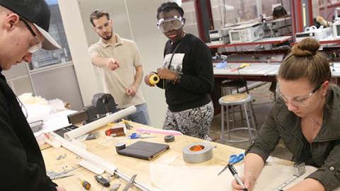 Four students work together on a design project